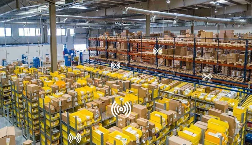 Multiple RFID readers transmitting signals in a large warehouse to enable seamless inventory tracking and management.