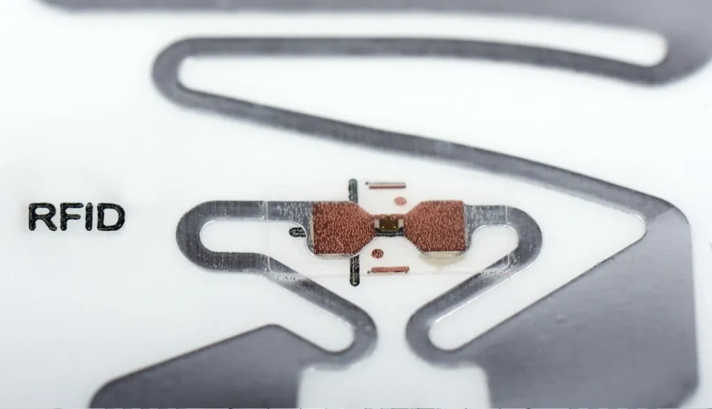 Internal view of an RFID card showing the embedded microchip and antenna that enable wireless data transmission.