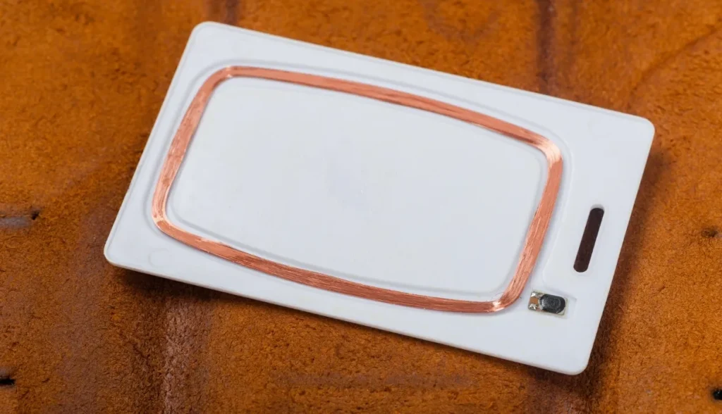 RFID chip embedding and inlay formation process, where the microchip is mounted onto the antenna substrate to create the card’s electronic core.