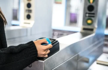 The Invisible Revolution Transforming Transportation with RFID Card Uses A person tapping an RFID card at a metro gate for quick access.