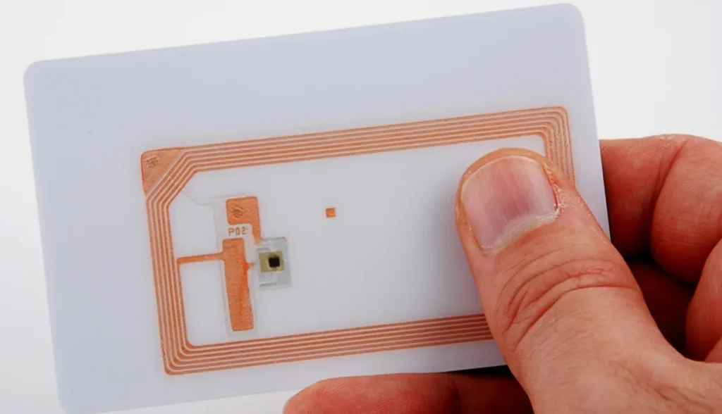 Close-up view of an RFID credit card showing the embedded antenna and microchip.