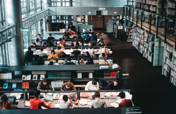 A Step-by-Step Guide to Implementing RFID Library Solutions Students studying in a modern library using RFID-based book management systems.