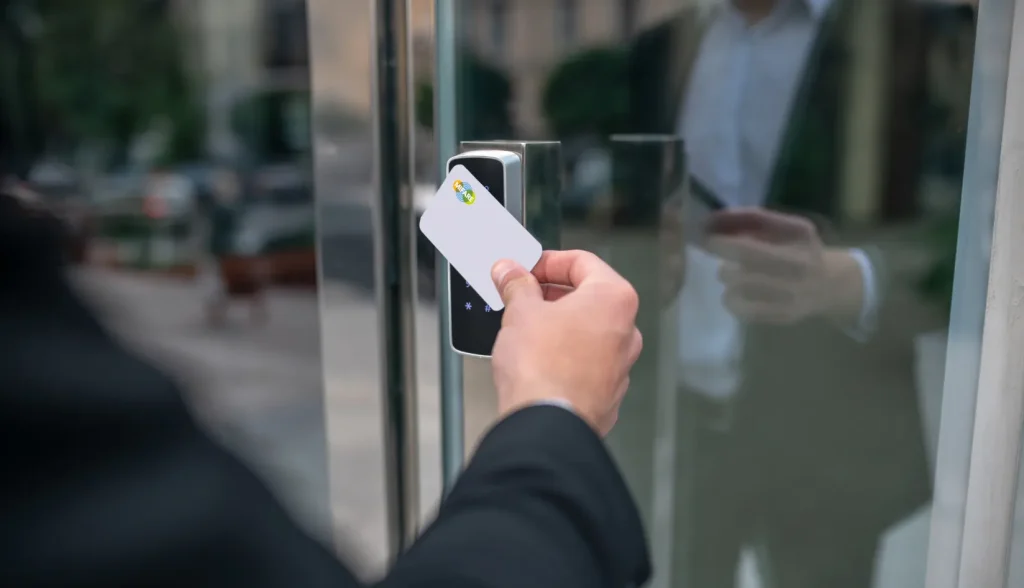 Person tapping a MIFARE card on a card reader to unlock a door.
