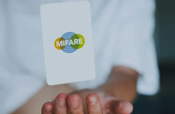 5 Most Common Applications of MIFARE RFID Cards in Modern Smart Systems MIFARE RFID card held in a person’s hand.