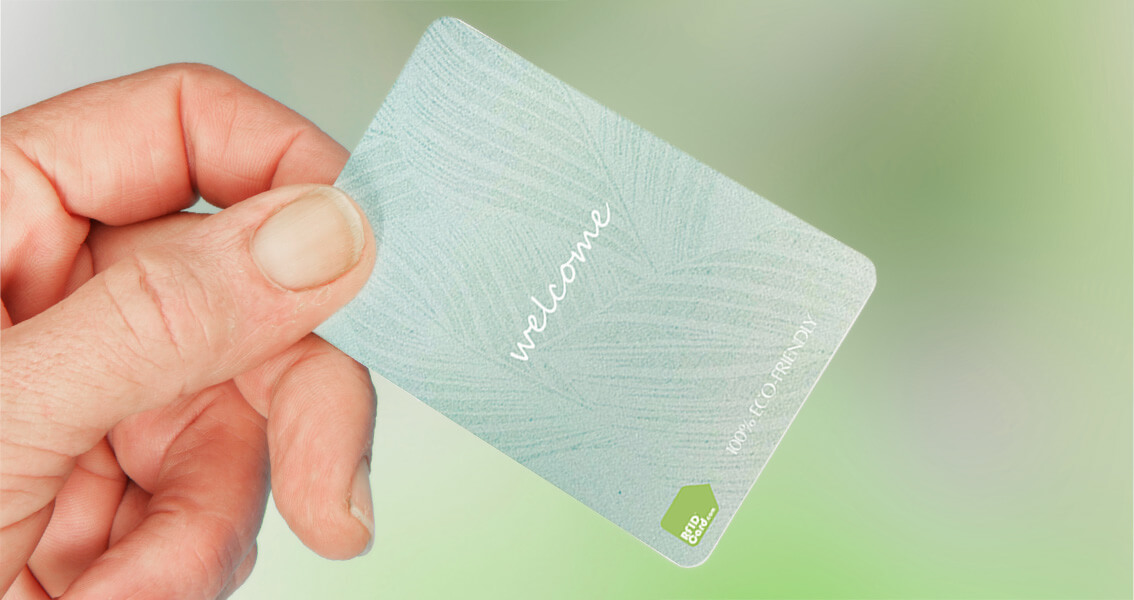 100 Paper Based RFID Card. Eco Friendly Upgrade from Plastic Cards hand holding light green 100 percent paper based eco friendly RFID card sustainable alternative to plastic cards