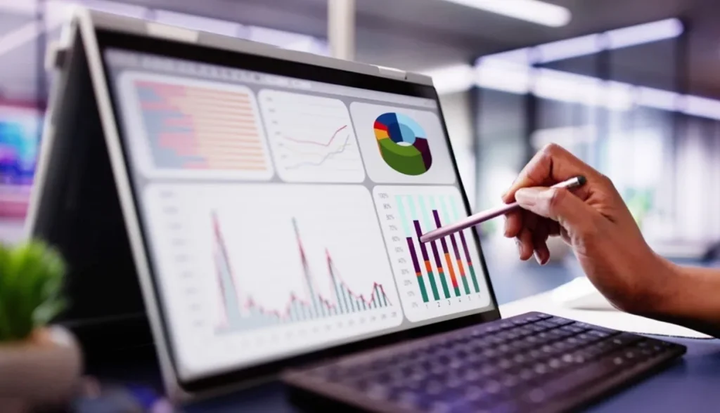 Analyst reviewing hotel performance data on a tablet dashboard.