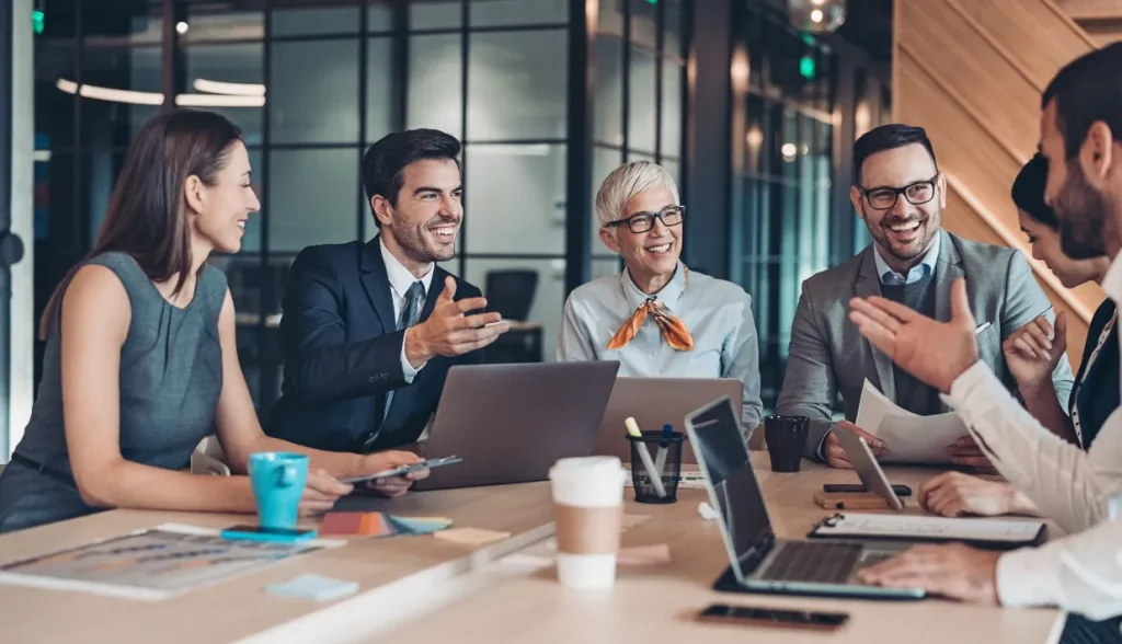 Business team discussing NFC card security requirements with a supplier in a modern office meeting.