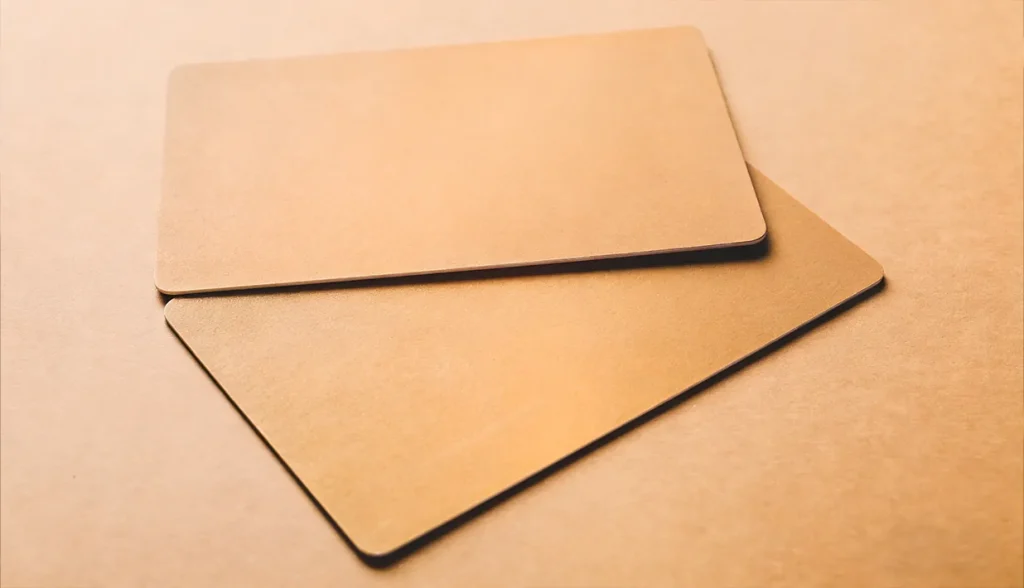 Blank gold RFID key cards stacked on a neutral background.