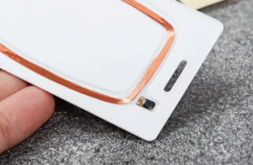 How to Choose the Right RFID Card Chip for Your Project Close-up of RFID card chip with copper coil and embedded microchip.
