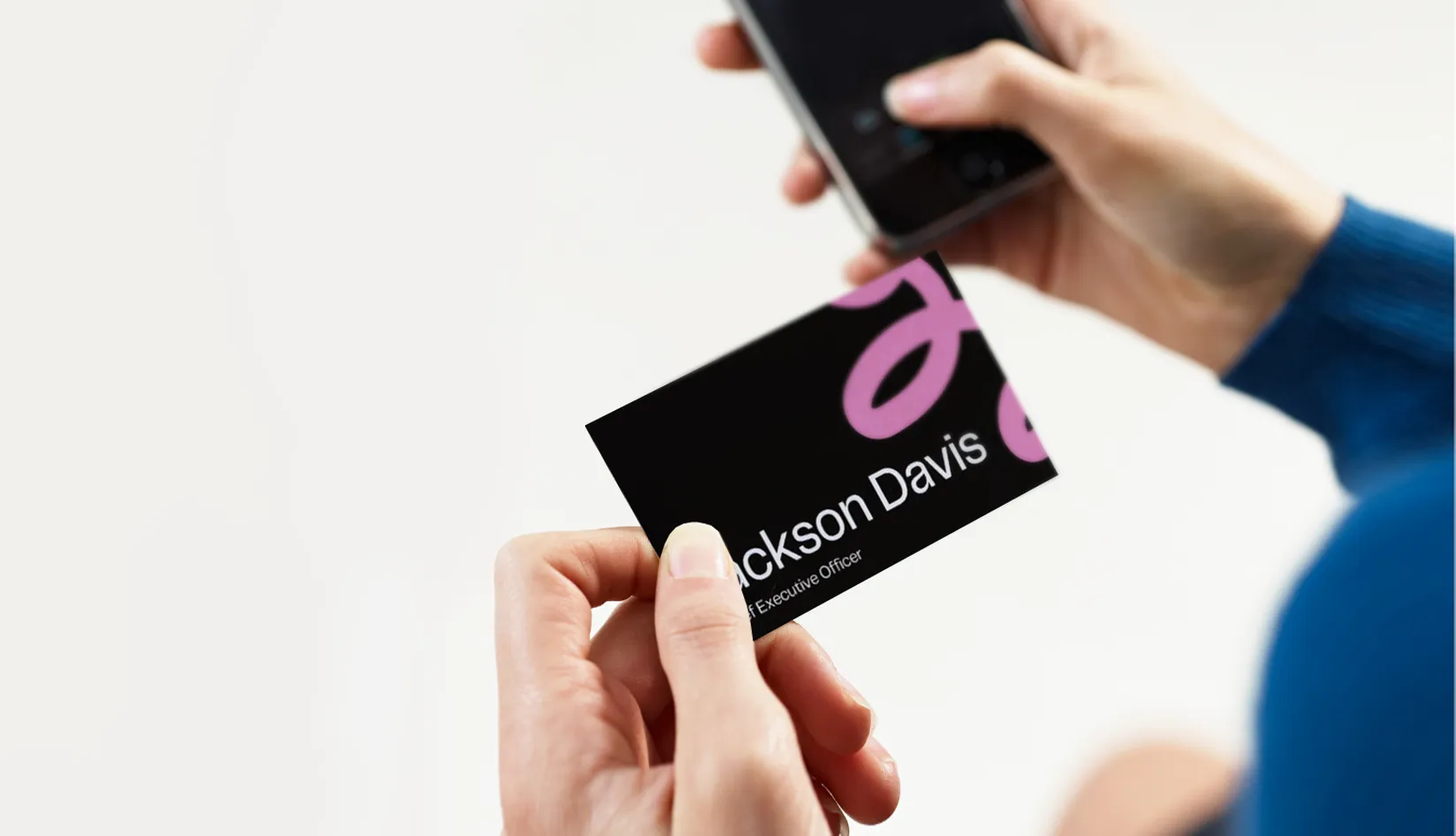 Which Industries Are RFID Business Cards Best Suited For Hand holding an RFID business card near a smartphone for instant digital contact sharing.