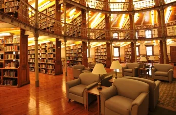 Why Smart Spaces Prefer RFID Membership Cards Over Mobile Apps Traditional library reading space with multi-level wooden bookshelves, comfortable lounge seating, and warm ambient lighting, representing a classic member-focused environment.